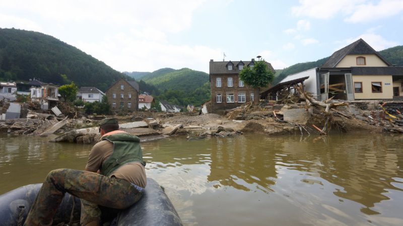An inflatable boat crossing the river Ahr near the Ahr valley bridge that had been destroyed by the flash flood in 2021.